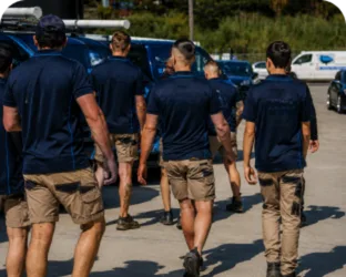 Plumbers walking to their service vans on a Turramurra job